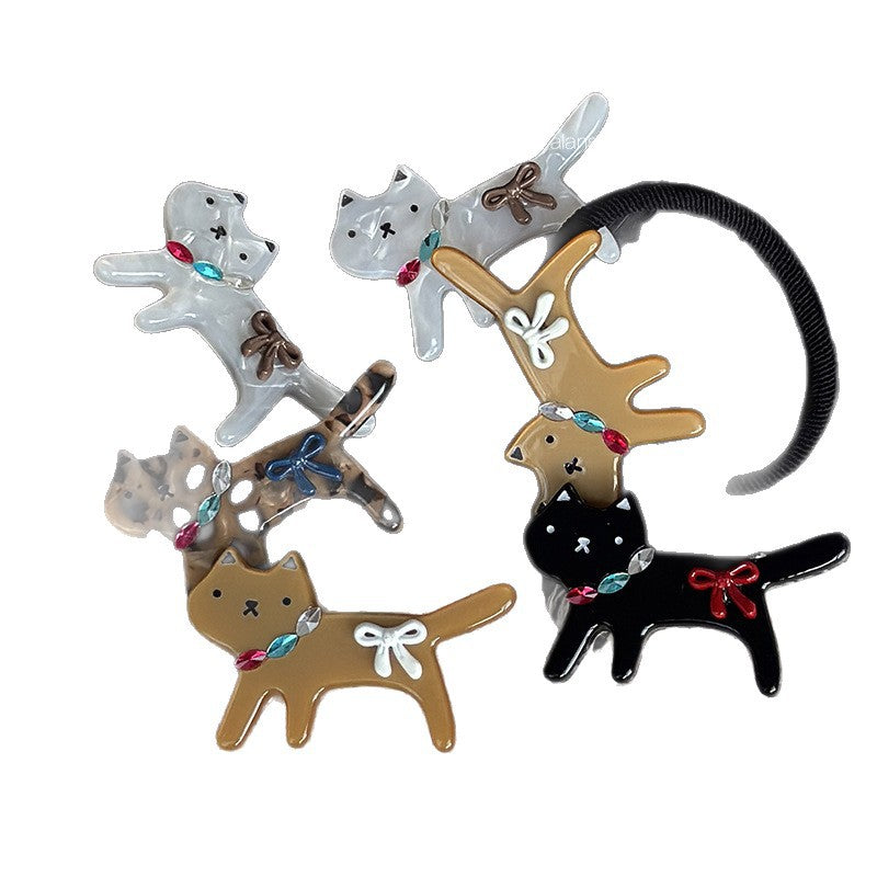Assorted acetate cat hair accessories showing clip and hair tie styles