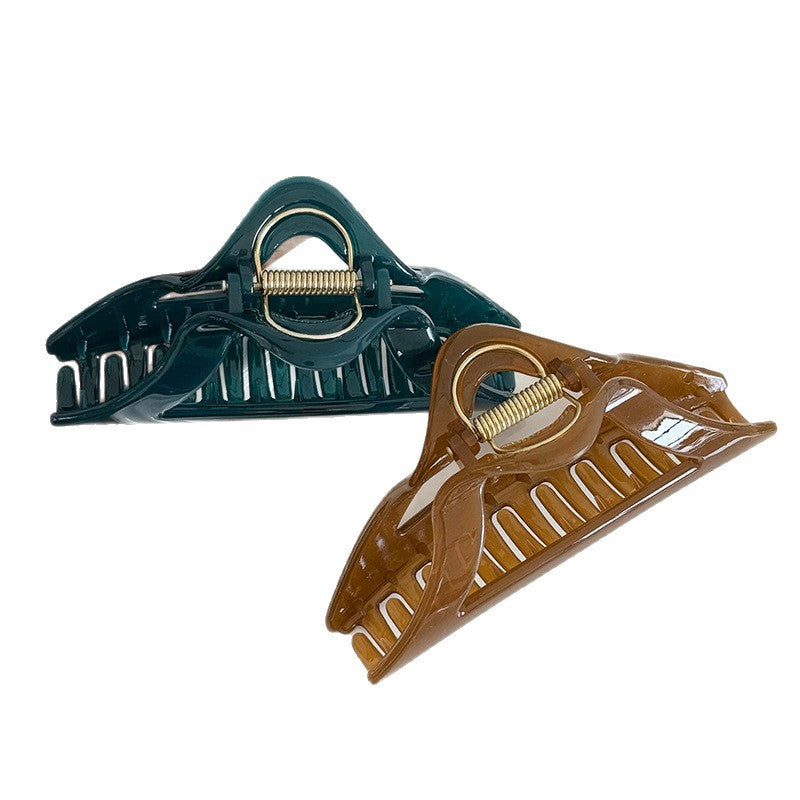 Deep green and brown resin triangle claw clips with visible metal springs