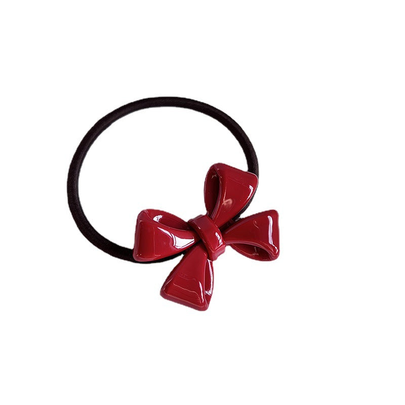 Dimensional bow hair tie shown as a decorative hair accessory