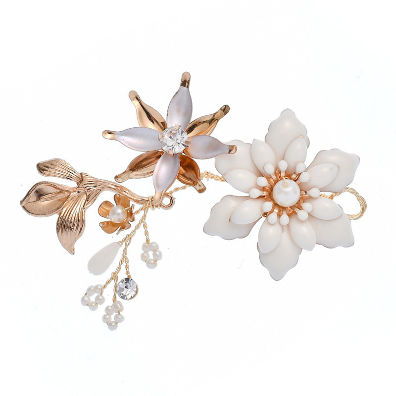 Close-up of a white floral hair pin with gold-color alloy details