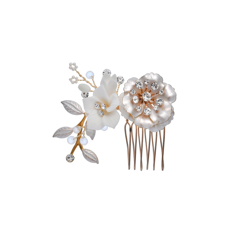Reverse view of floral bridal comb showing its metal teeth and ceramic blossoms