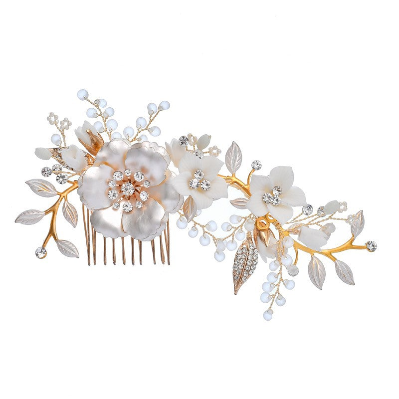 Wide floral hair comb with crystal accents, white flowers, and decorative leaves