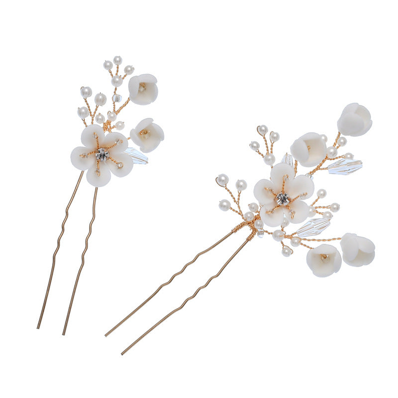 Pair of white ceramic flower hair pins with pearl and crystal details