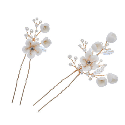 Pair of white ceramic flower hair pins with pearl and crystal details