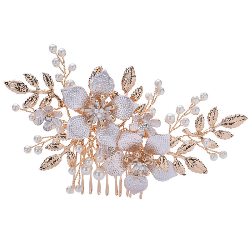Floral bridal hair comb with pearl accents and gold-colored alloy leaves