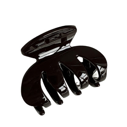Dark brown resin claw clip with a glossy finish and rounded teeth