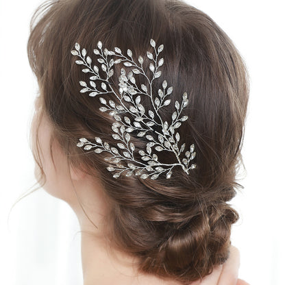 Leaf-shaped rhinestone hair vine styled into a bridal updo
