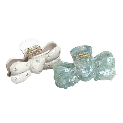 White and teal acetate bow claw clips with rhinestone details