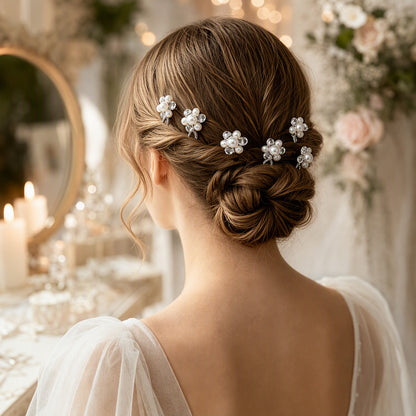 Faux pearl and crystal flower U-pins arranged in a bridal updo