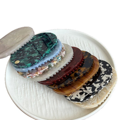 Assorted acetate mirror combs in patterned color options