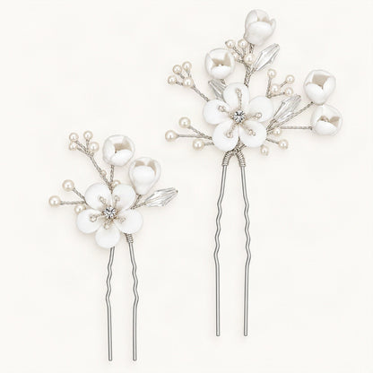 White ceramic flower hair pins with faux pearls and crystal accents on blue [FITINY Hair]