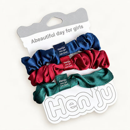 Muted multicolor satin scrunchies shown as a three-pack [FITINY Hair]