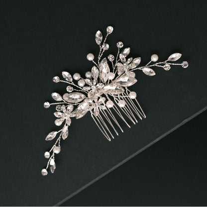 Close view of silver bridal hair comb with crystal and pearl embellishments