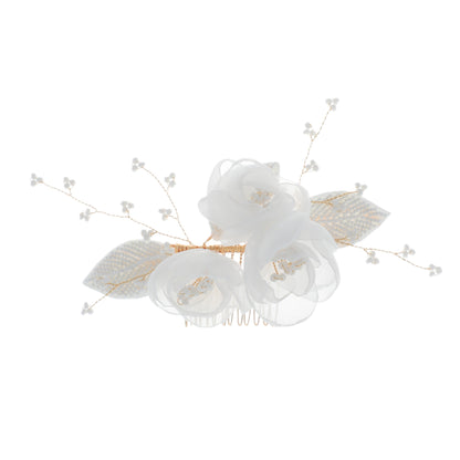 Decorative floral hair comb shown against a lace wedding fabric backdrop