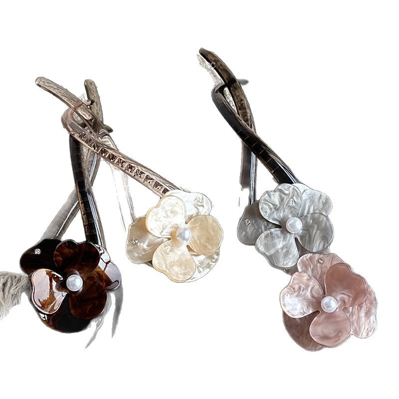 Acrylic camellia flower twist hair clips in pink, chocolate, gray, and cream