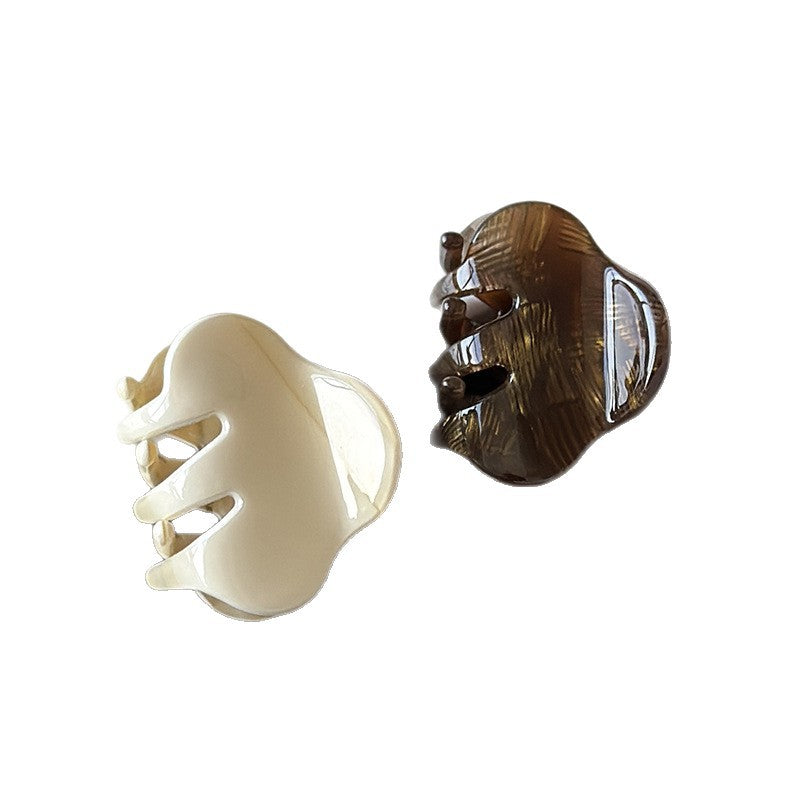 Cream and brown small cellulose acetate claw clips shown from the side
