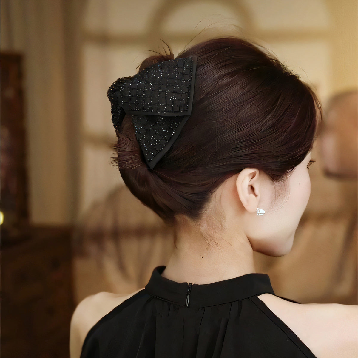 Black rhinestone satin claw clip worn in an updo