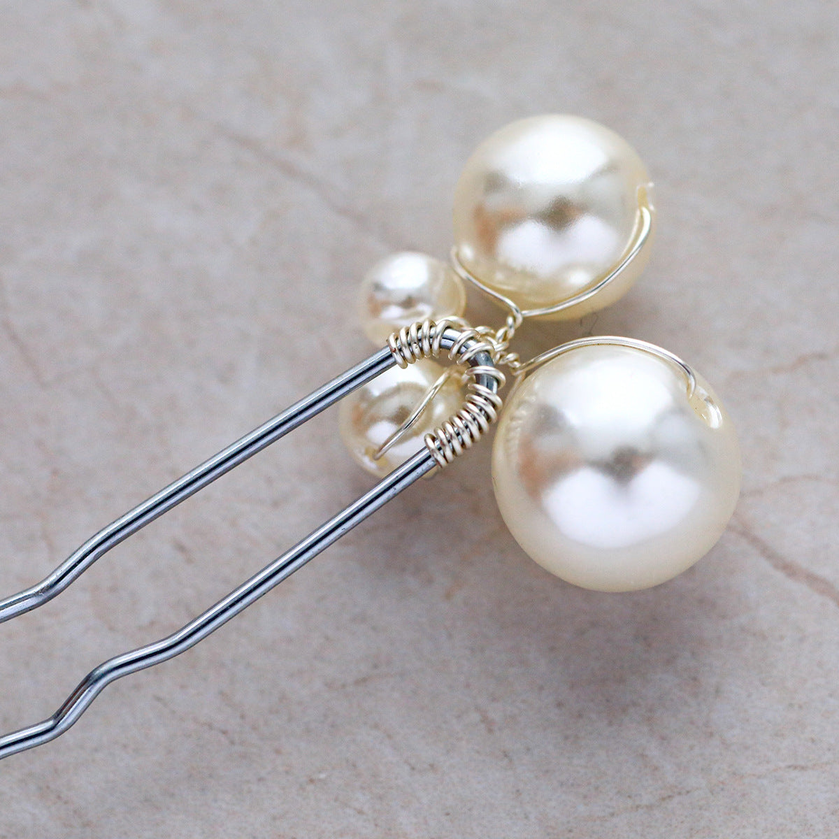Close-up of faux pearls attached to silver-colored hair pins