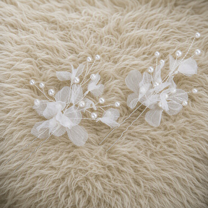 Silver floral U pins arranged as wedding updo accessories