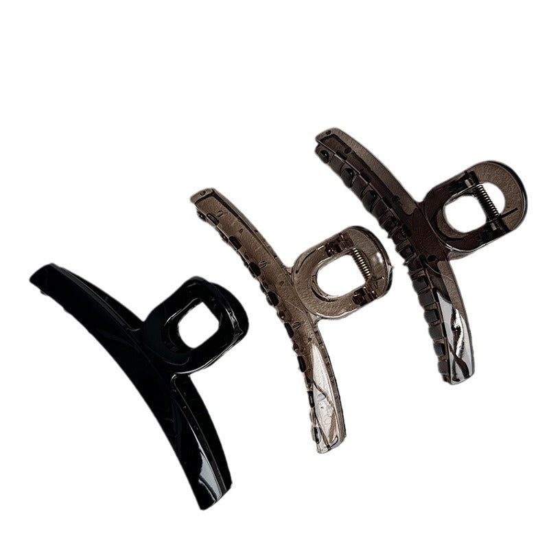 Three 13 cm resin claw hair clips in black, translucent grey, and translucent black