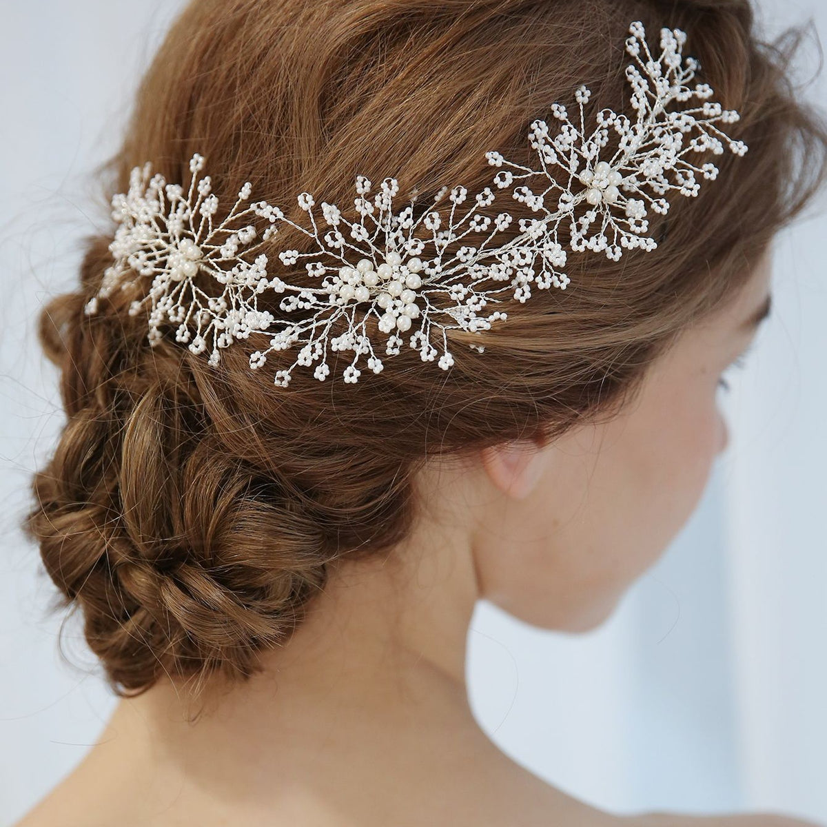 Close-up of faux pearl branches worn in a bridal hairstyle