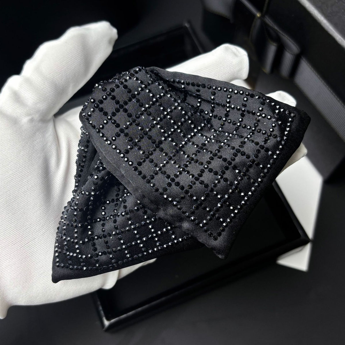 Close-up of the black satin and rhinestone pattern on the hair clip