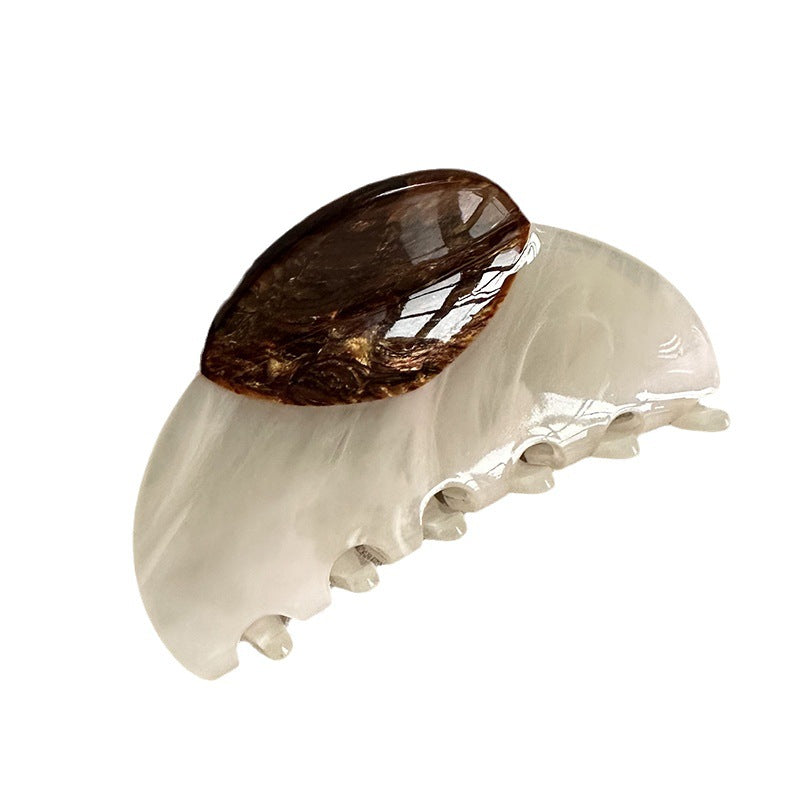Large acetate claw clip with a brown woodgrain accent and ivory-colored body
