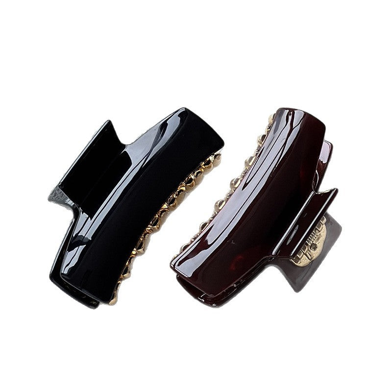 Black and pearl brown cellulose acetate claw clips with glossy finishes