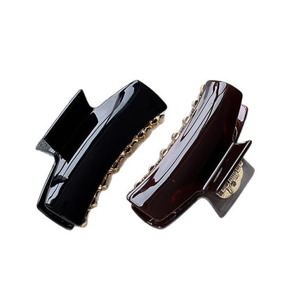 Black and pearl brown cellulose acetate claw clips with glossy finishes