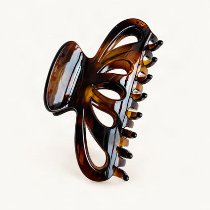 Transparent brown resin claw hair clip in a close product view [FITINY Hair]