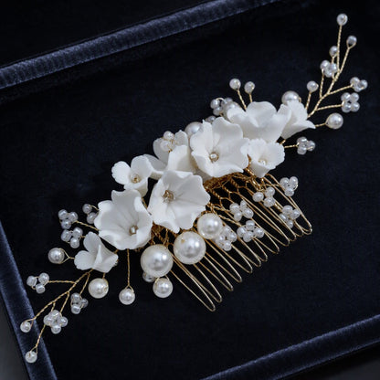 Close-up of sculpted flowers, faux pearls, and metal comb teeth
