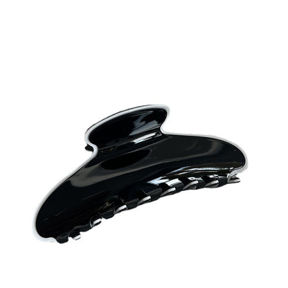 Glossy black cellulose acetate claw clip with a white contrasting edge