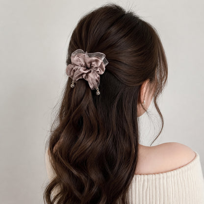 Satin scrunchie styled in a half-up hairstyle