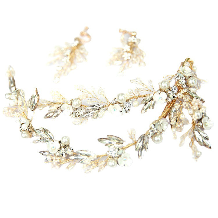 Gold bridal hair clip arranged with faux pearls, rhinestones, and crystal floral accents