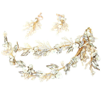 Gold bridal hair clip arranged with faux pearls, rhinestones, and crystal floral accents