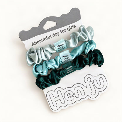 Teal satin hair ties arranged in a three-scrunchie set [FITINY Hair]
