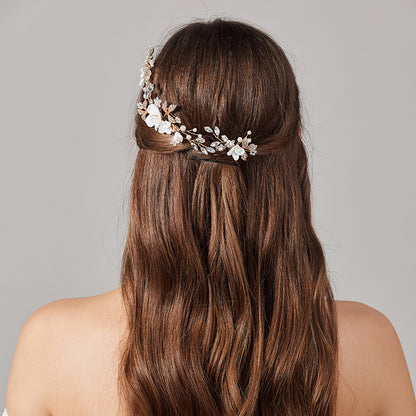 Bridal floral hair accessory worn at the back of long hair