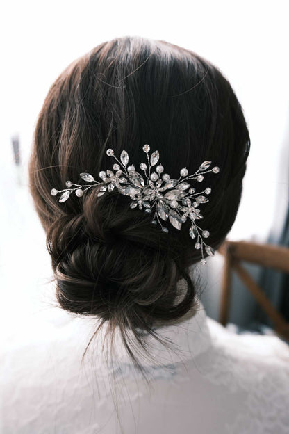 Bridal updo styled with a sparkling crystal and pearl hair comb