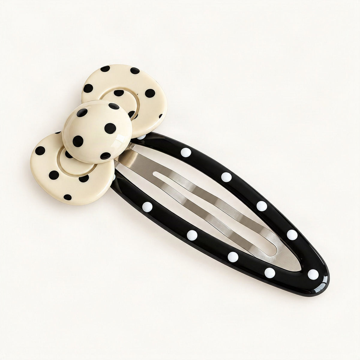 Curved cream and black spotted hair clip in a close product view [FITINY Hair]