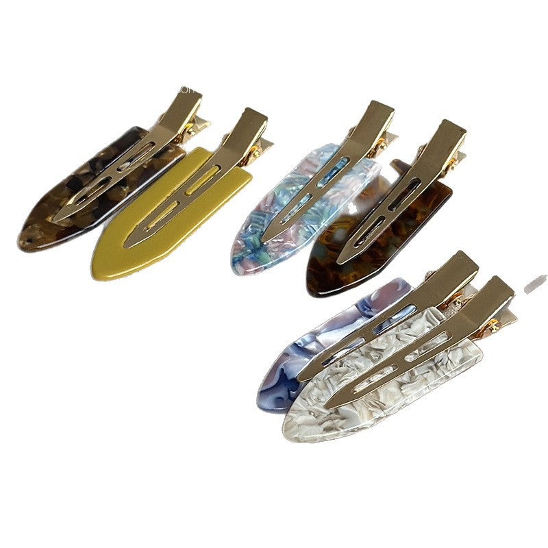 Assorted acetate hair clips in floral patterns and mustard yellow