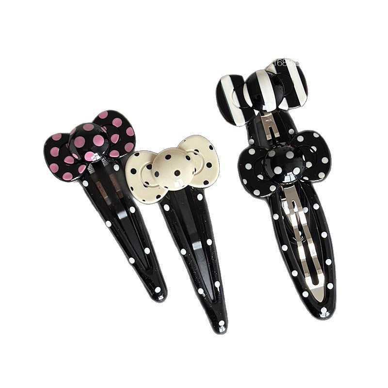 Black and white striped acetate hair clip with a simple patterned design