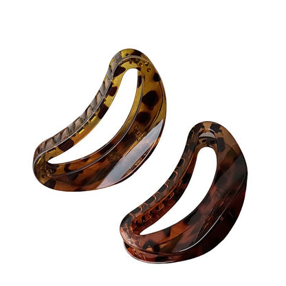 Two curved resin claw clips in glossy tortoiseshell brown and dark brown
