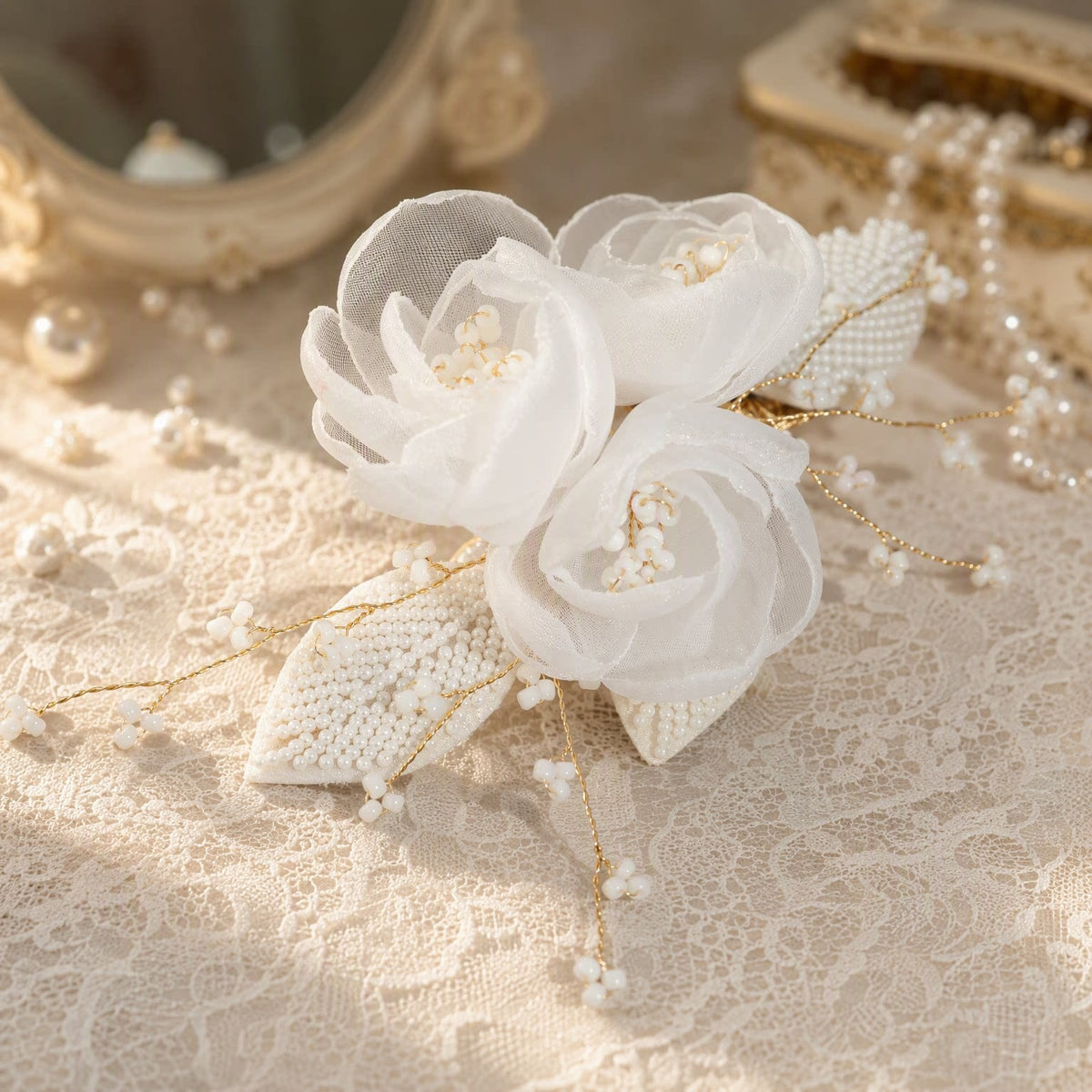 Close view of layered white mesh flowers and faux pearl detailing