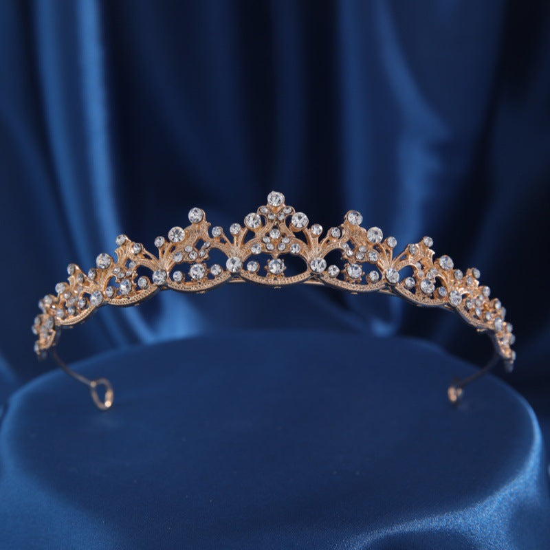 Gold crown headband with clear rhinestones in a front view