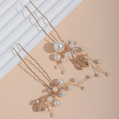 Close-up view of the decorative hair pins and their branching pearl details