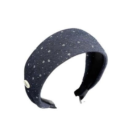 Navy wide floral headband isolated against a white background