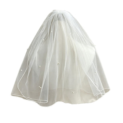 Full view of a double-layer wedding veil with pearl embellishments