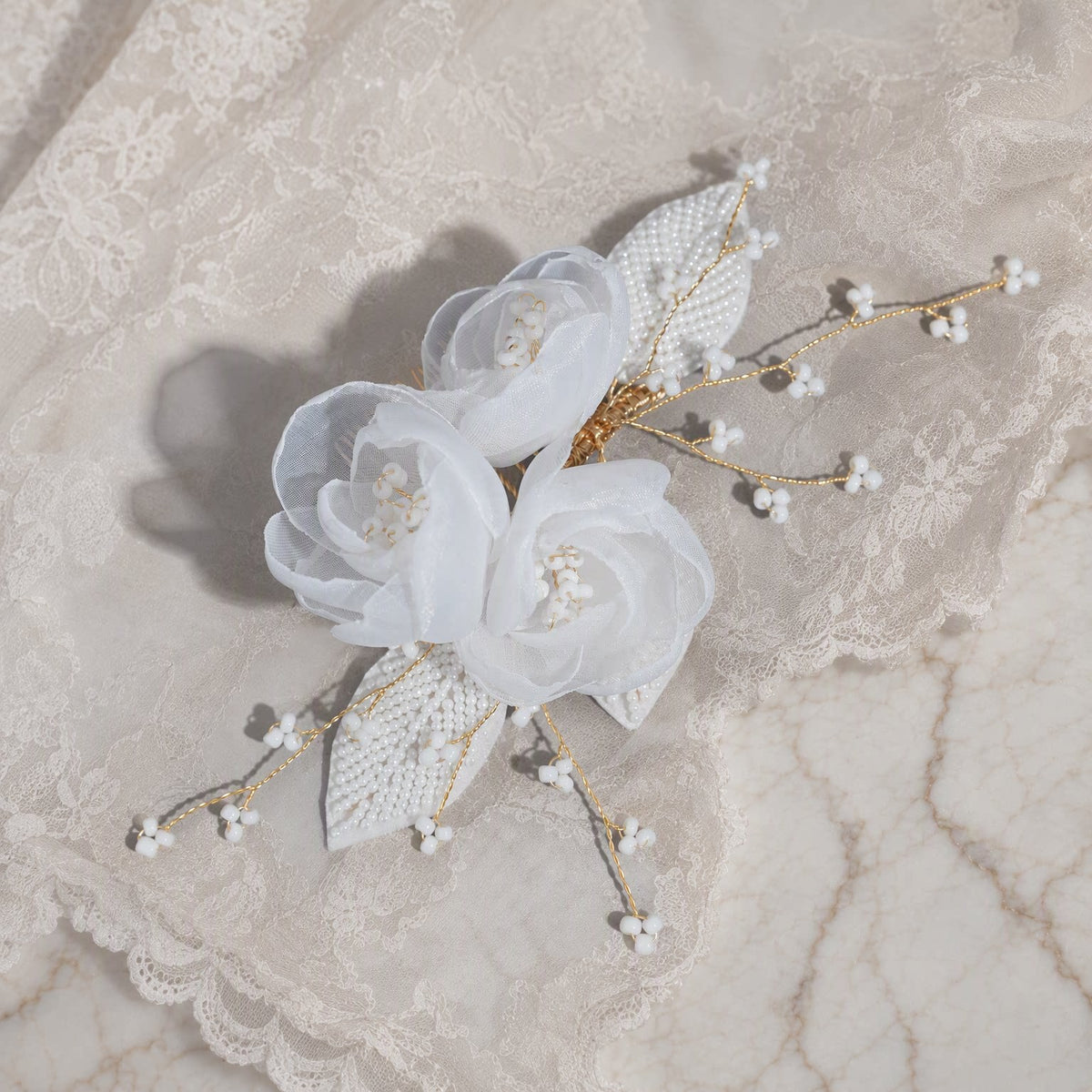 Overhead view of the floral bridal comb with pearl leaves and wire branches