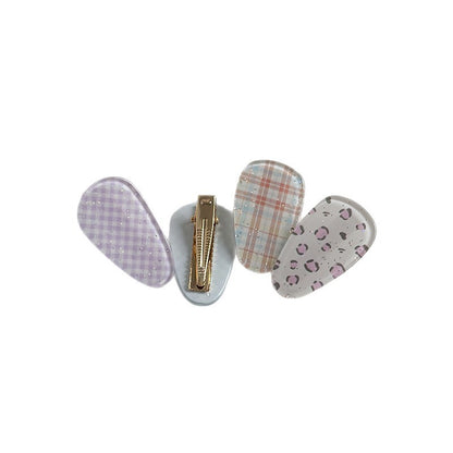 Acrylic patterned side hair clips with glitter detail and a gold-tone metal back