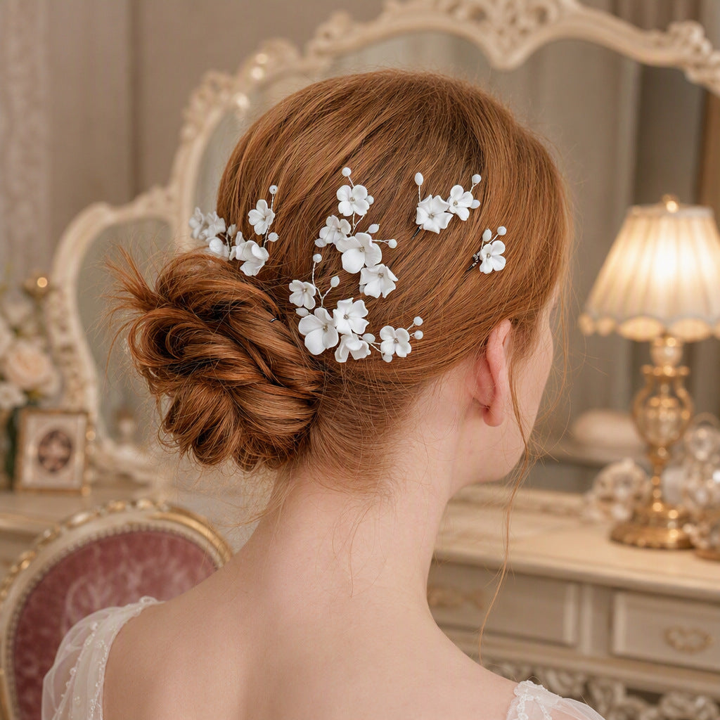 Black floral hair pins arranged through a wedding bun